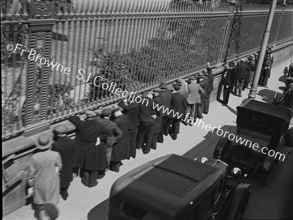 SPECTATOR WATCH CRICKET THROUGH RAILINGS OF COLLEGE PARK T.C.D.